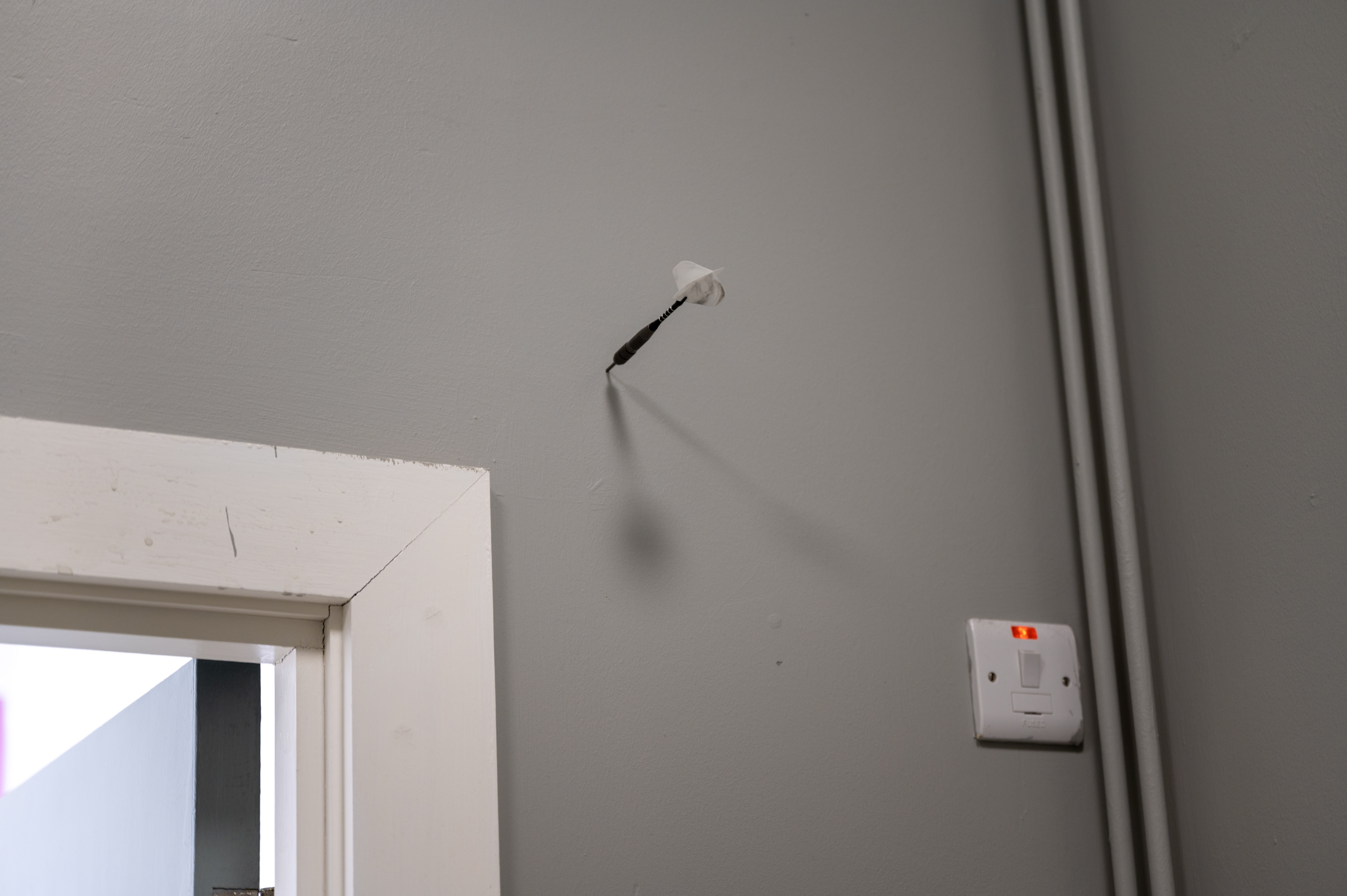 a dart stuck into a wall