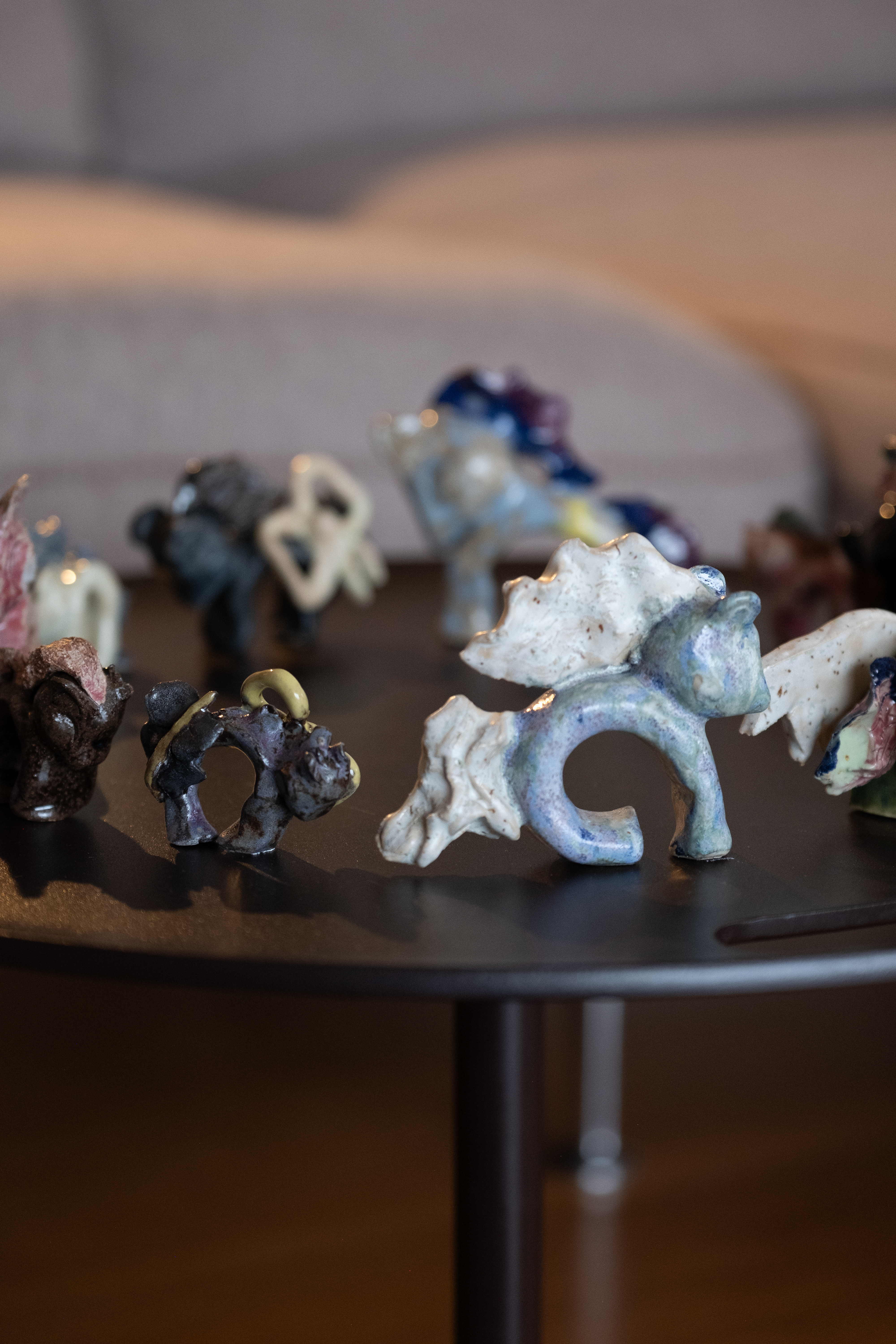 a small table on which sits a circle of toy horses