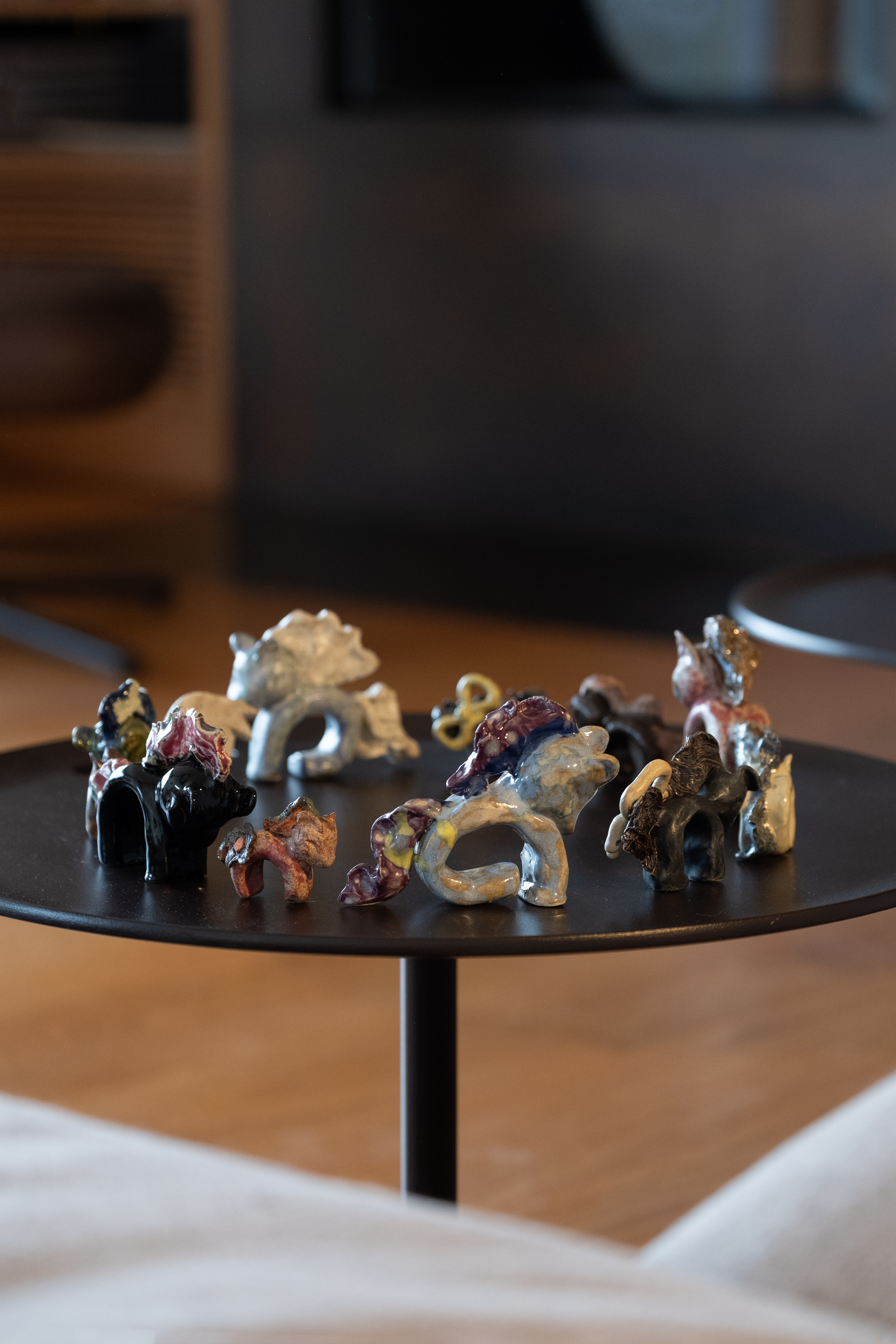 a small table on which sits a circle of toy horses